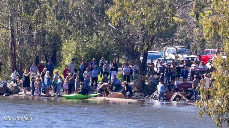 A big crowd watches on as Adam Farquharson launches his giant pumpkin in the Tumut River. Picture by John Stanfield/Tumutians
