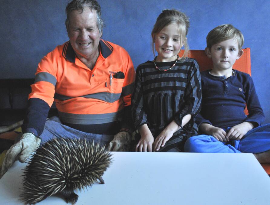 UNUSUAL GUEST:  Frank with two of his grandchildren, Regan and Knox Blair-Dermody checking out the cute critter. 