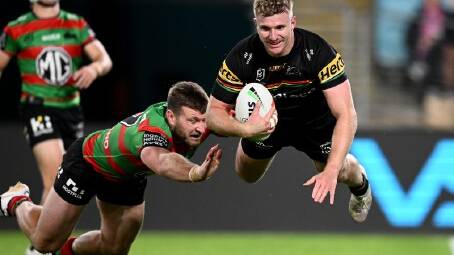 Luke Garner scores for Penrith as the defending premiers thumped beleaguered South Sydney. (Dan Himbrechts/AAP PHOTOS)