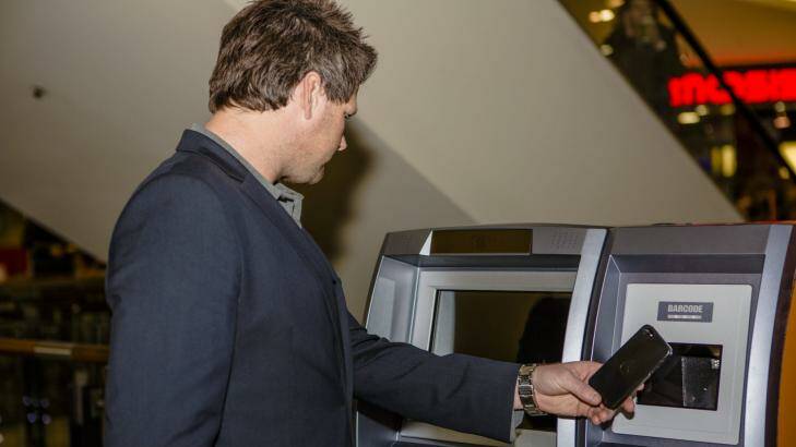 ABA Technology director Robert Masters uses the ATM. Photo by: Jamila Toderas