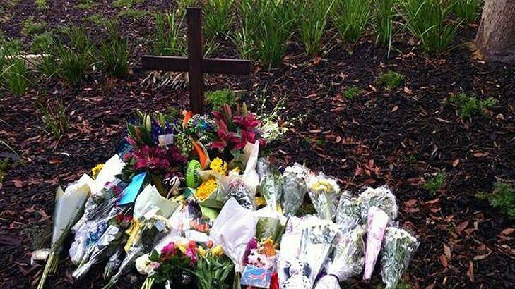 Tributes were placed at a cross erected at Scotch College today. Photo: Channel 10