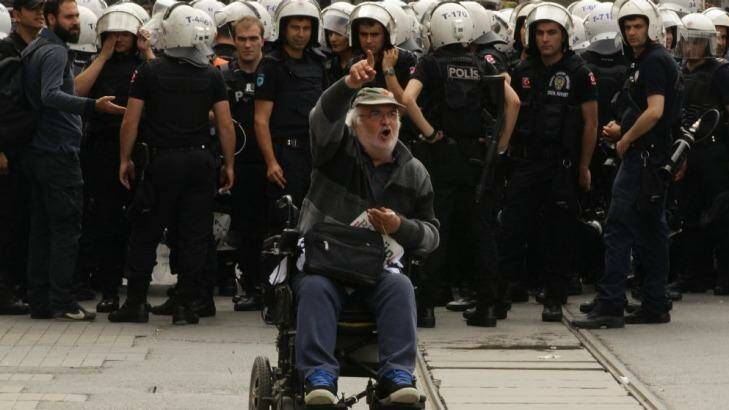 A man protests in front of a police line in Taksim Square Photo: Kate Geraghty