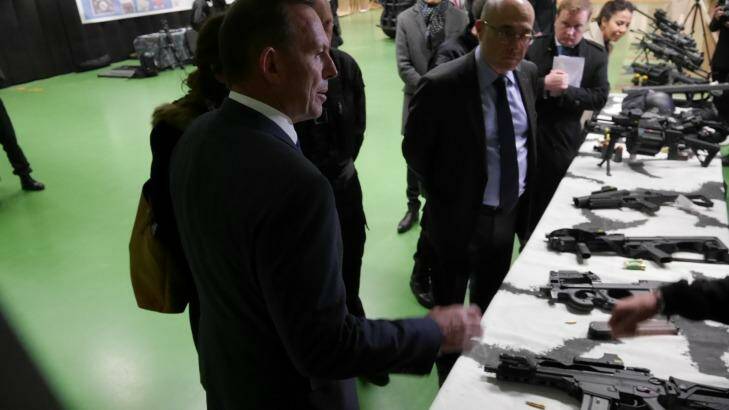 Australian prime minister Tony Abbott's inspects weapons at the  RAID offices in France. Photo: Nick Miller