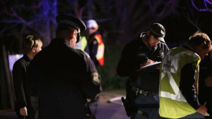 Police take notes after the crash. Photo: Getty Images/Cole Bennetts