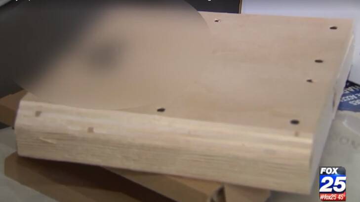 The wood was cut to size and fit perfectly in the original PS4 packaging. Photo: YouTube/Fox News
