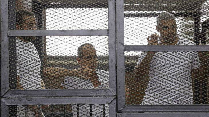 Al-Jazeera journalists Baher Mohamed, Peter Greste and Mohammed Fahmy behind bars in court in Cairo. Photo: Asmaa Waguih