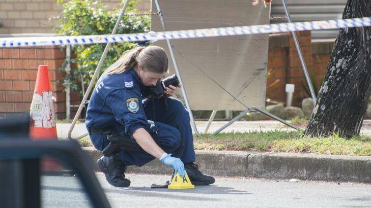 Evidence inspected by police near a stolen car used by gang of heavily armed bank robbers. Photo: Christopher Pearce