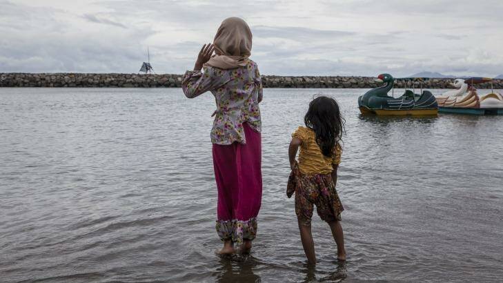 A decade after the tsunami, two girls play on the beach in Banda Aceh.