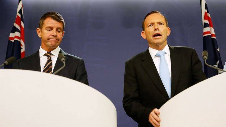 The re-election chances of the government of NSW Premier Mike Baird, left, are being eroded by the unpopularity of Prime Minister Tony Abbott. Photo: Daniel Munoz