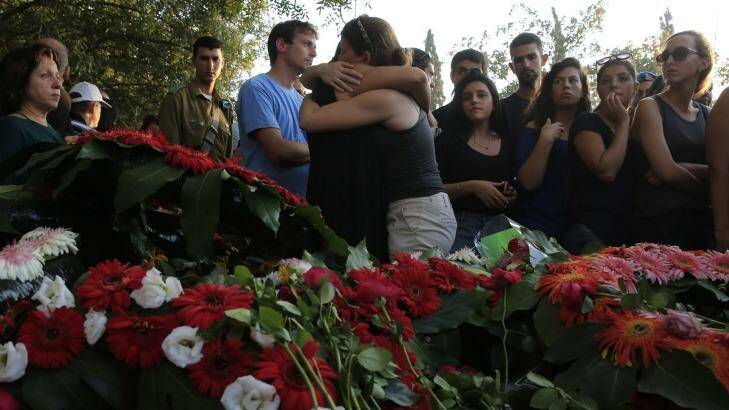 Mourners at the funeral of Ze'evik Etzion, a 55 year old security officer who was killed by a Palestinian mortar shell near the Israel Gaza border on Thursday. Photo: AP Photo/Tsafrir Abayov