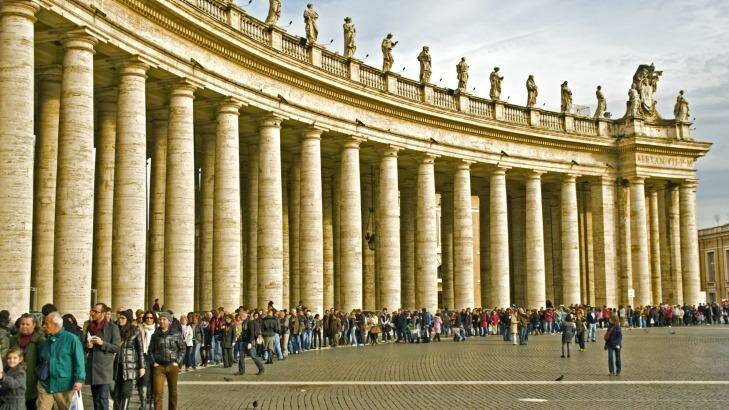 Visitors waiting in line along the Colonnade of the St Peter Square to enter into the St. Peter Cathedral in Rome, Italy. Photo: iStock