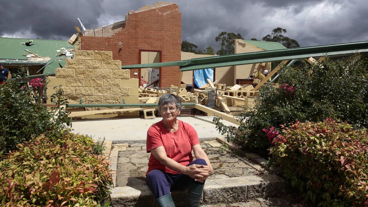 Storm damage at Forbes Creek following a cyclone-like storm on Saturday night. Jan McKergow in front of her damaged home. Photo: Jeffrey Chan.