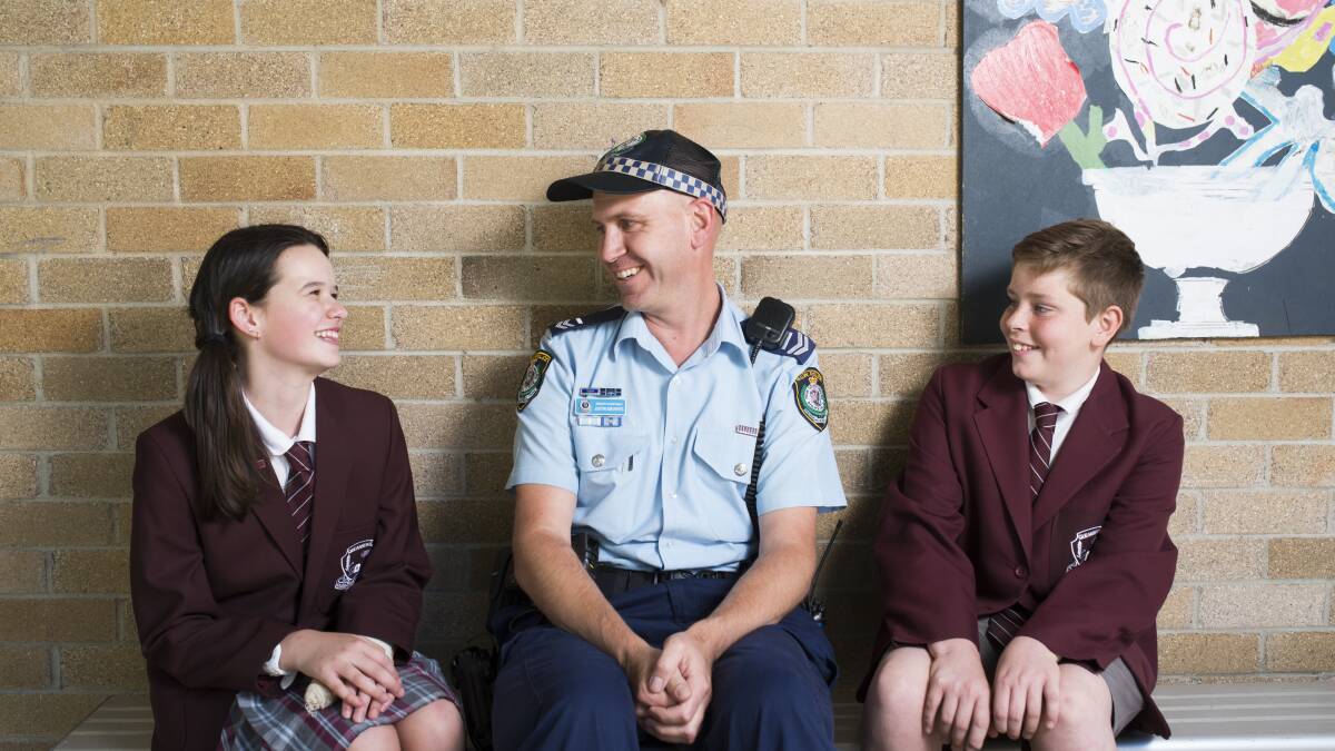 Queanbeyan Public School year 6 students Amy McAlister and Rory Kendal-Rowe with Senior Constable Justin Sieverts. Photo: Rohan Thomson.