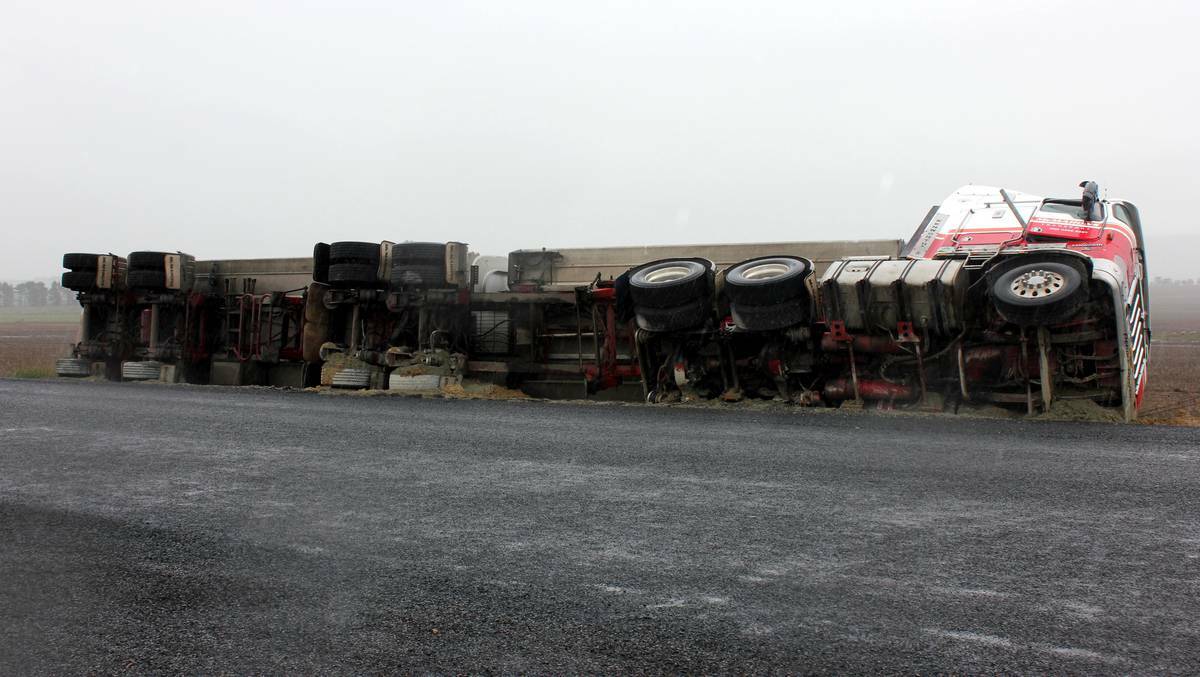 GOULBURN: A TRUCK carrying sawdust hit a spot of trouble on Friday afternoon when it tipped over in the wet weather. Photo Antony Dubber, Goulburn Post.