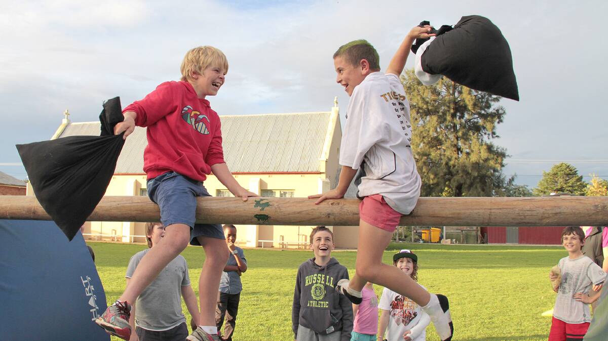 COOTAMUNDRA: Enjoying themselves on the greasy pole at the Sacred Heart fete were Digby Leahy and Darcy Maher.