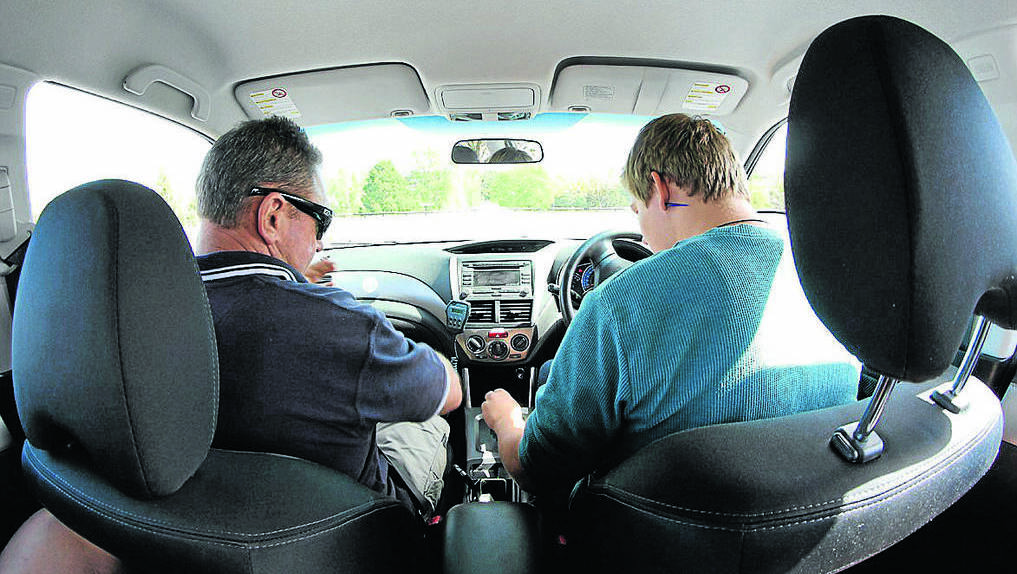 COOMA: Snowy Mountains Driving School's Craig Williams with Monaro High student Jamie Clifford in the 'skid car'. Photo: Tina Zunic.