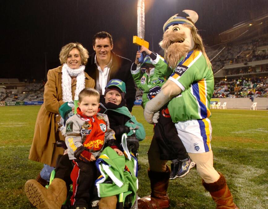 Queanbeyan's own Victor the Viking with former Canberra Raider Matt Adamson and his family in 2006. Photo: Melissa Adams.