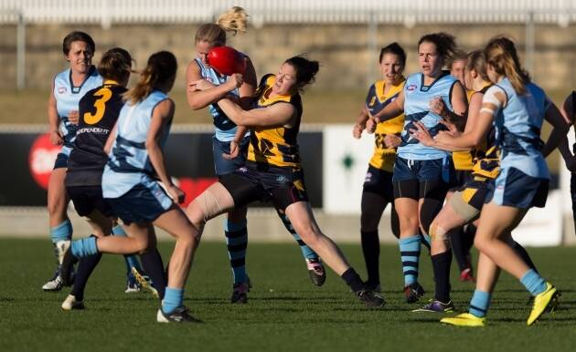 The AFL Canberra women's representative side locking horns with their AFL Sydney opponents at Manuka Oval last Saturday. Four Queanbeyan Tigerettes players took to the field for the Canberra side. Photo: AFL NSW/ACT.