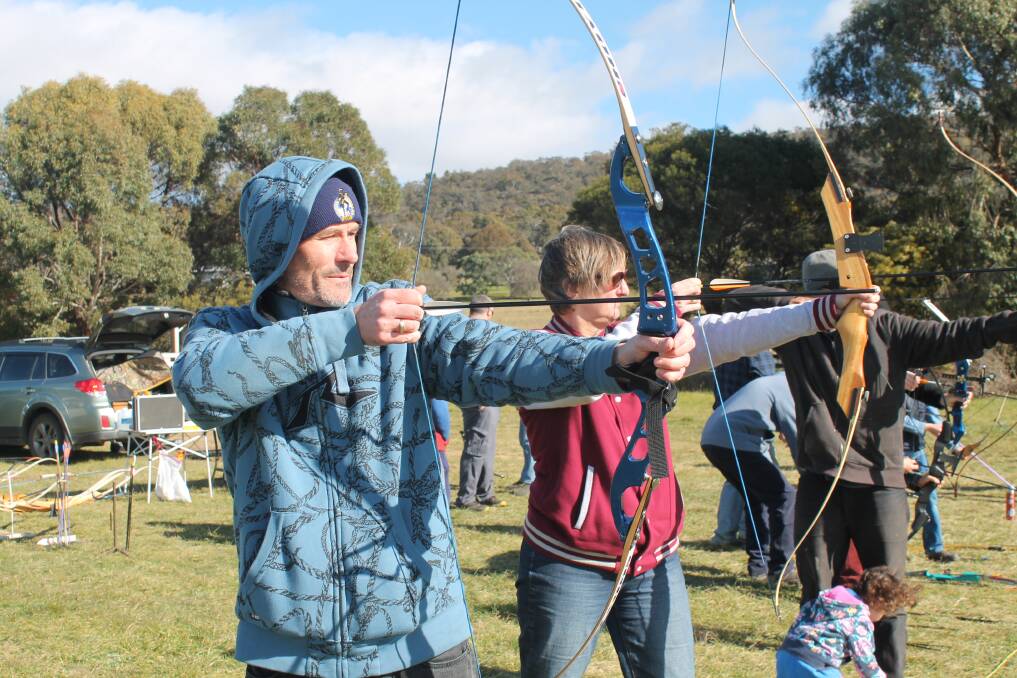 Bungendore residents Darren Crew and Denise Crew try out Queanbeyan Archery's new range at the Bungendore Showground. Photo: Joshua Matic.