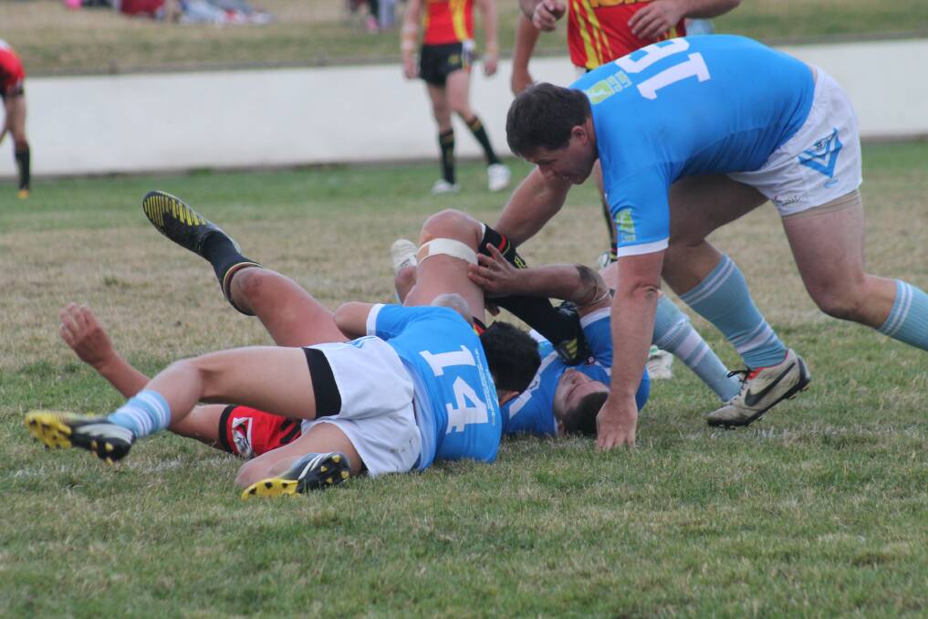 Queanbeyan Blues players Tevian Arona and Daniel Dole wrestle a a Gungahlin Bulls player to ground back on May 24. Photo: Joshua Matic.
