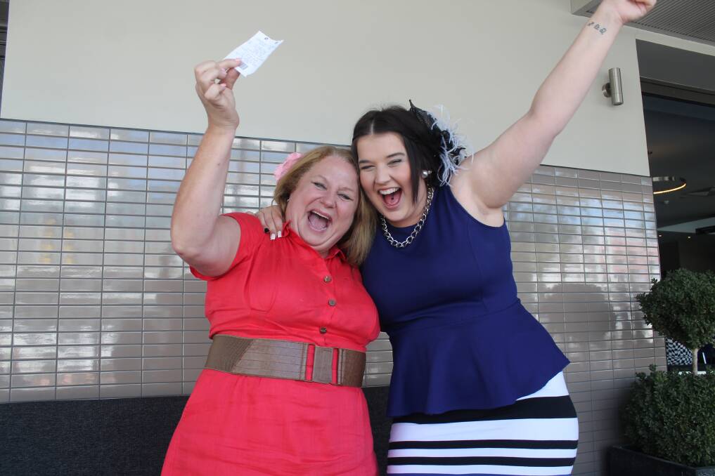 Queanbeyan Melbourne Cup winning punter Cheryl Baker celebrates her win with Danni Venobles at the Royal Hotel on Tuesday afternoon. Photo: Joshua Matic.