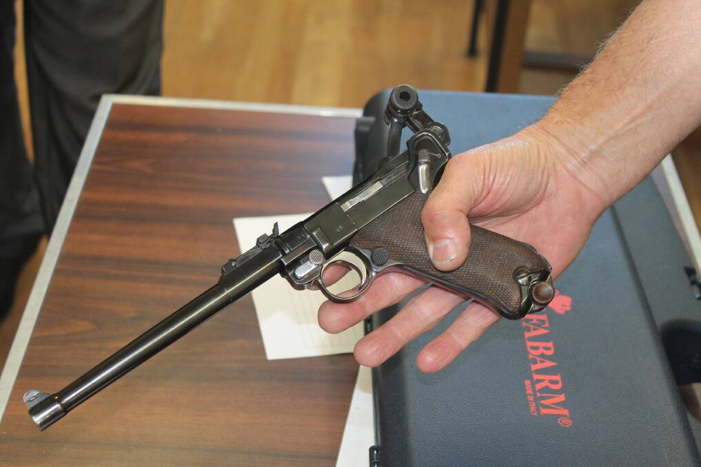 A non-dunctioning 1914 model pistol used in World War I kept as a historical antique.