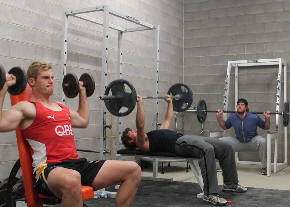 Queanbeyan Tigers NEAFL players Dave Smith, Josh Bryce and Nick Hull enjoy their new gym space. Photo: Joshua Matic.