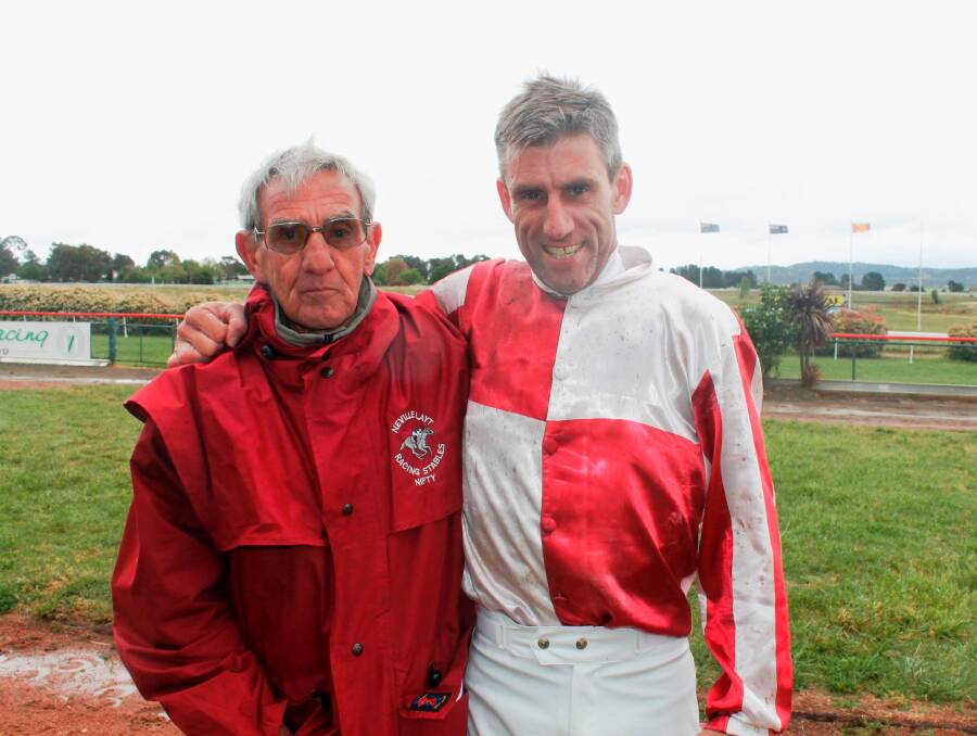Queanbeyan horse trainer Neville Layt with son and jockey Adrian Layt, after their horse Grand Proposal won its first race in 10 months at the Queanbeyan Racing Club last Tuesday. Photo: Joshua Matic.