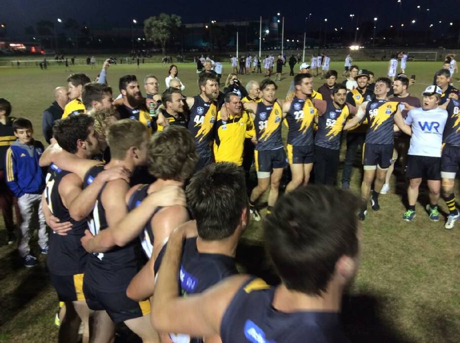 The Queanbeyan Tigers celebrate their emphatic 10.7.67 to 7.7.49 AFL Canberra premiership win over Ainslie on Saturday night. Photo: Queanbeyan Tigers.