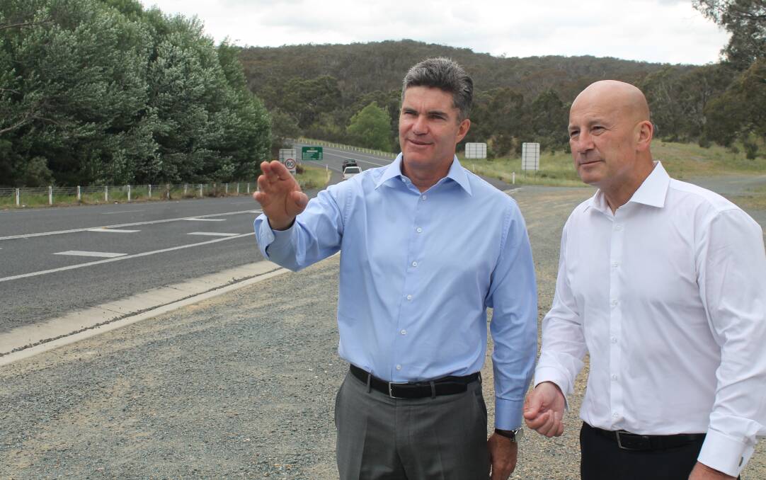 Local Country Labor candidate for Monaro Steve Whan inspects the Kings Highway near Captains Flat Road with NSW opposition leader John Robertson on Saturday. Photo: Joshua Matic.