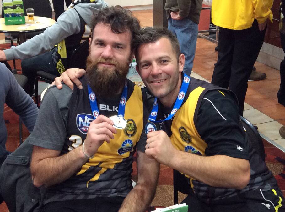 Queanbeyan Tiger Michael Wescombe, right, celebrates his AFL Canberra premiership at the Tiger's Club last Saturday night: Photo: Queanbeyan Tigers.