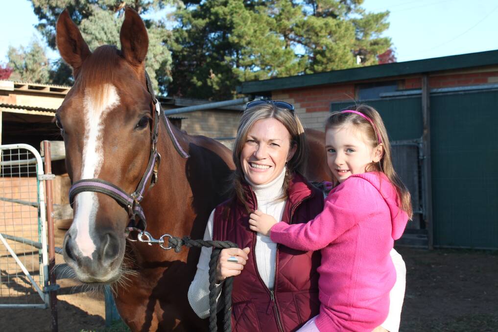 Queanbeyantrainer Regina Buckley with her daughter, Jessica Newham, and horse Lily of the Meadow, at her stable in West Queanbeyan. 	        		       Photo: Joshua Matic