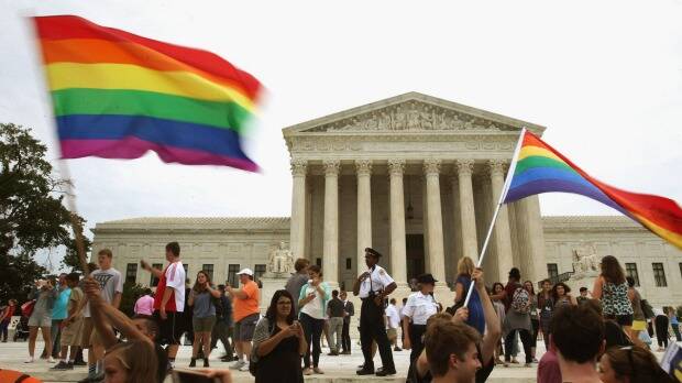 People celebrate in front of the US Supreme Court after the ruling in favor of same-sex marriage June 26, 2015 in Washington, DC. The high court ruled that same-sex couples have the right to marry in all 50 states. Photo: Getty Images