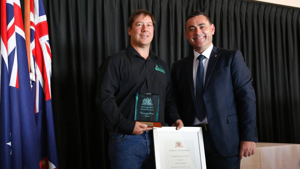 Former Monaro Panthers president Mauro Davanzo (left) receives his NSW Premier's Award for community service from member for Monaro John Barilaro. Photo: Kim Pham