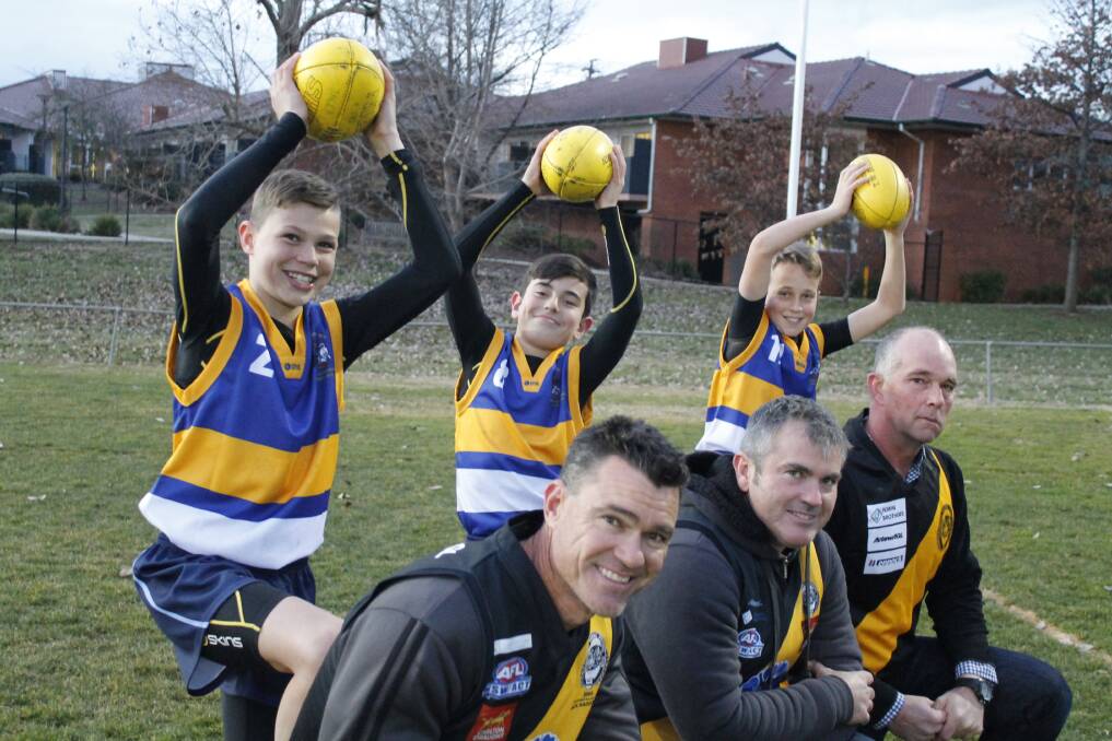 The next generation of local AFL stars come from good stock with juniors Jack Armstrong, Jordan Gilbert and Lachlan Mertz pictured with their dads and former Tigers players Mark, Jason and Guy. Photo: Steph Konatar.