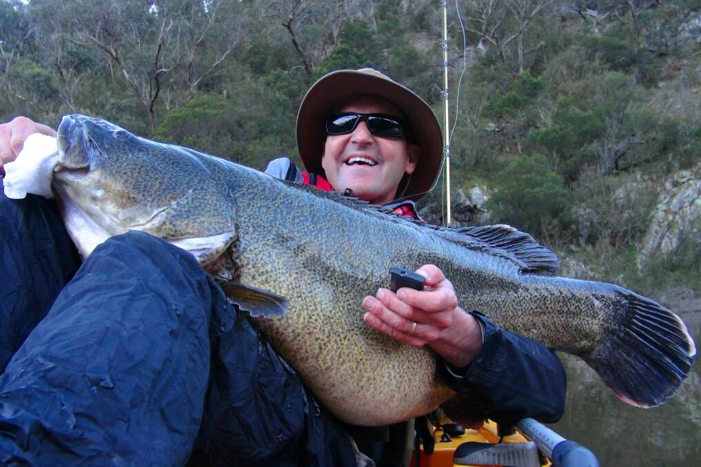 Rob Paxevanos with a giant Murray cod caught on the Googong Dam. Photo: Supplied.
