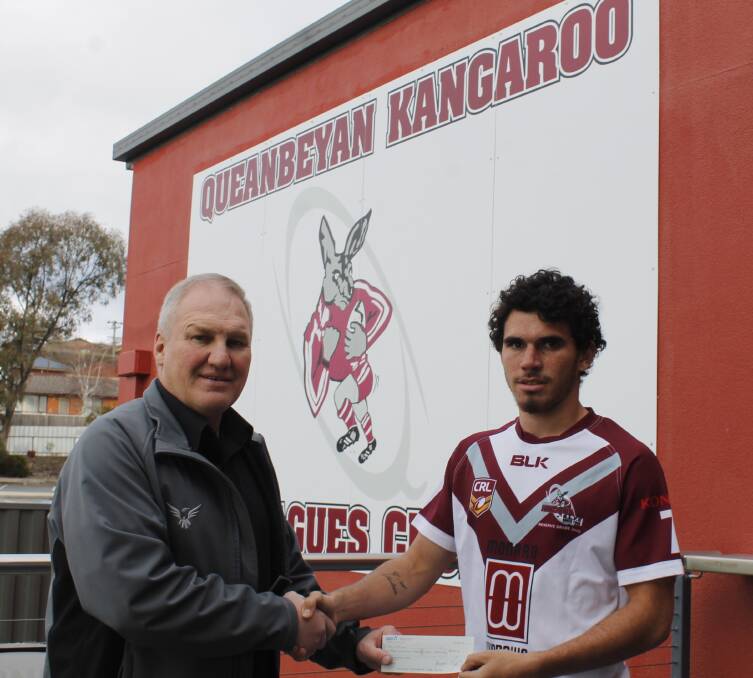Kangaroos general manager Leigh Kiely presenting the Queanbeyan City Council Sports Assistance Scheme Grant to promising footballer Tre Williams. Photo: Steph Konatar.