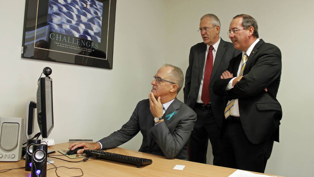 Communications minister Malcolm Turnbull runs an NBN speed test at Codarra Advanced Systems in Queanbeyan on Wednesday, with Codarra Advanced Systems managing director Warren Williams and local member for Eden-Monaro, Peter Hendy.