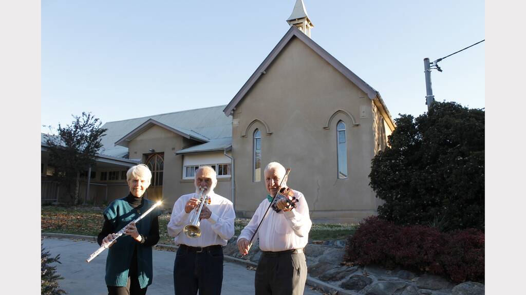 Brindabella Orchestra musicians Doreen Cope, Brian O'Neill and John Cope prepare for the 'Autumn Leaves' concert at The Queanbeyan Uniting Church.