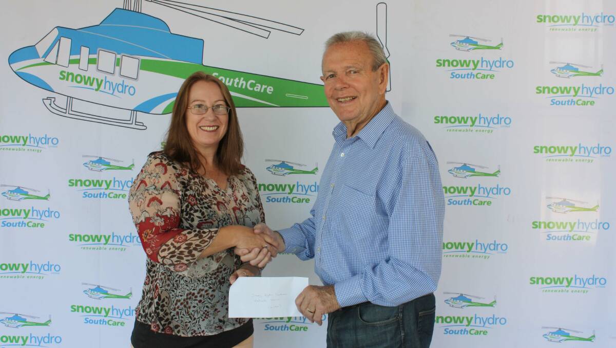QAS President Barry Cranston presents the society cheque for funds raised at the 7th QAS Charity Art Show to Alison Tonkin (Fundraising Manager for Snowyhydro Southcare).