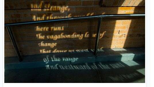Shadows cast from the floating poetry panels at the Queanbeyan City Library. Photo: Flickr / GARYSCAT.