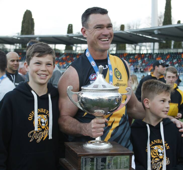 Mark 'Merv' Armstrong with sons Jack, 12 and Michael, 10 after the Tigers grand final. Photo: Steph Konatar.
