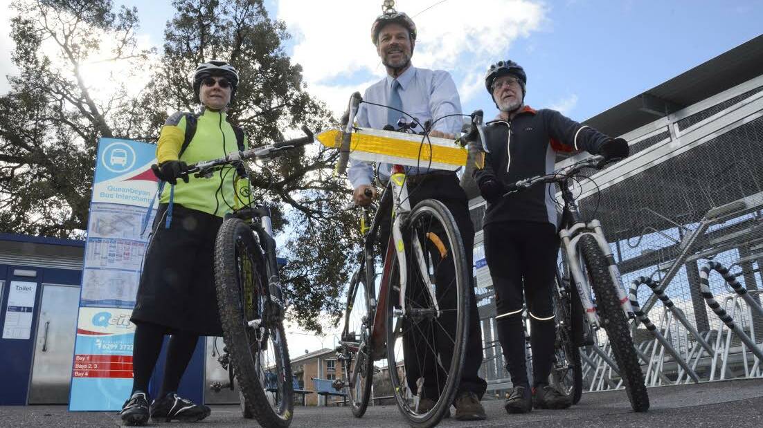 Queanbeyan cyclists Kay Pendlebury, Dr David Poland and Terry Dixon are concerned about lock-up cycle cage security at the new bus interchange and a couple of nearby safety traps. Photo: Ron Aggs.