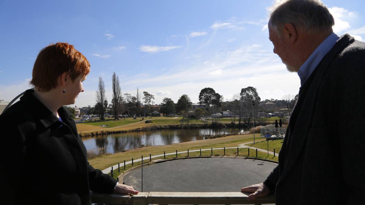 Queanbeyan City Council cultural development officer Georgina Perri and SERRG coordinator Geoff Prior imagine what the river and foreshore will look like once the 26 sculptures are installed. Photo: Kim Pham.