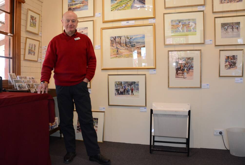 Artist in residence Ray Barnett stands proudly in front of his exhibition wall at Bungendore Fine Art gallery on the eve of their 10th anniversary. Photo: Ron Aggs.