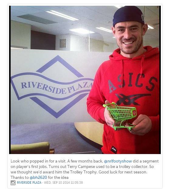 Canberra Raiders captain Terry Campese looks pretty chuffed with his novelty trophy for pushing the most trolleys up the Riverside Plaza escalator. Photo: Instagram / Riverside Plaza.