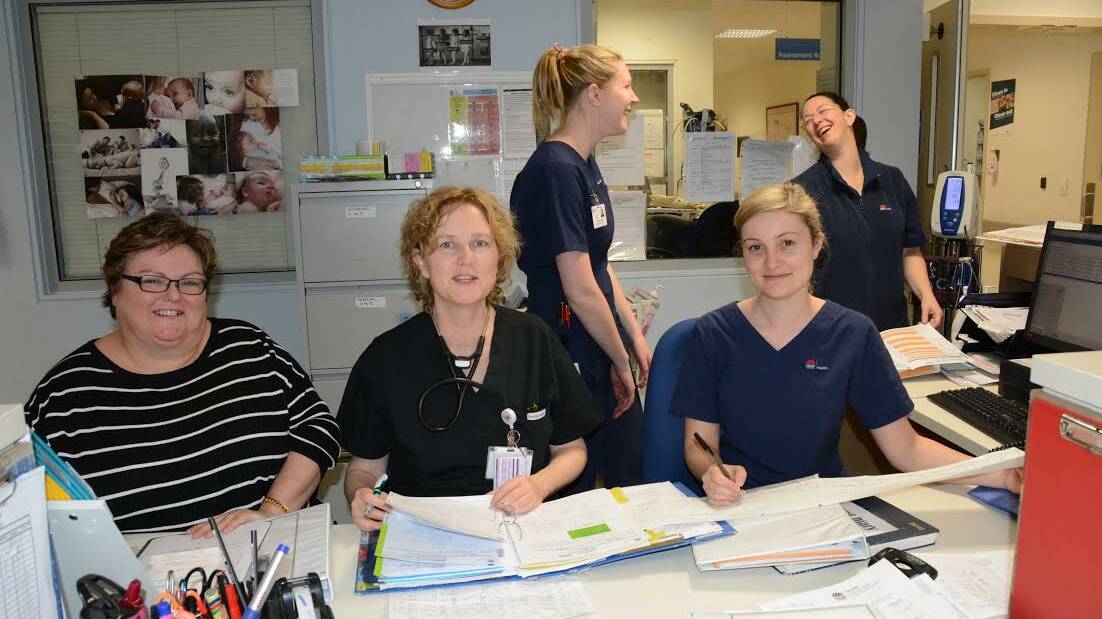 Administrative assistant Debbie Gavan takes stock of the day's work in the birthing unit at Queanbeyan hospital with Dr Jeannie Ellis and midwife Amanda Sibley (seated), while Nicola Baker and Tash Jeppesen share a moment of humour. Photo: Ron Aggs.