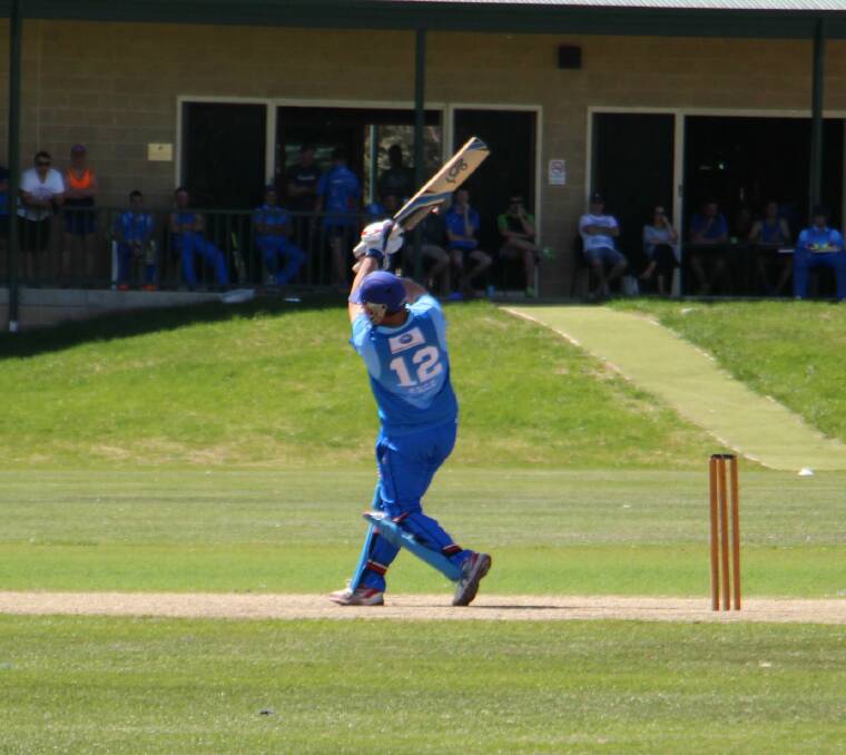 Mark Higgs launches a ball down the ground during Queanbeyan's T20 match against North Canberra-Gungahlin last week. Photo: Miles Thompson.