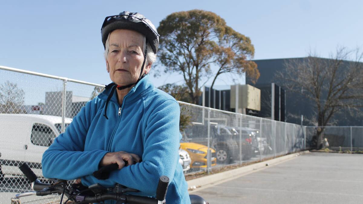 Carole Bennett is just one of many residents questioning why a new fence has been erected in a Riverside Plaza car park. Photo: Kim Pham.