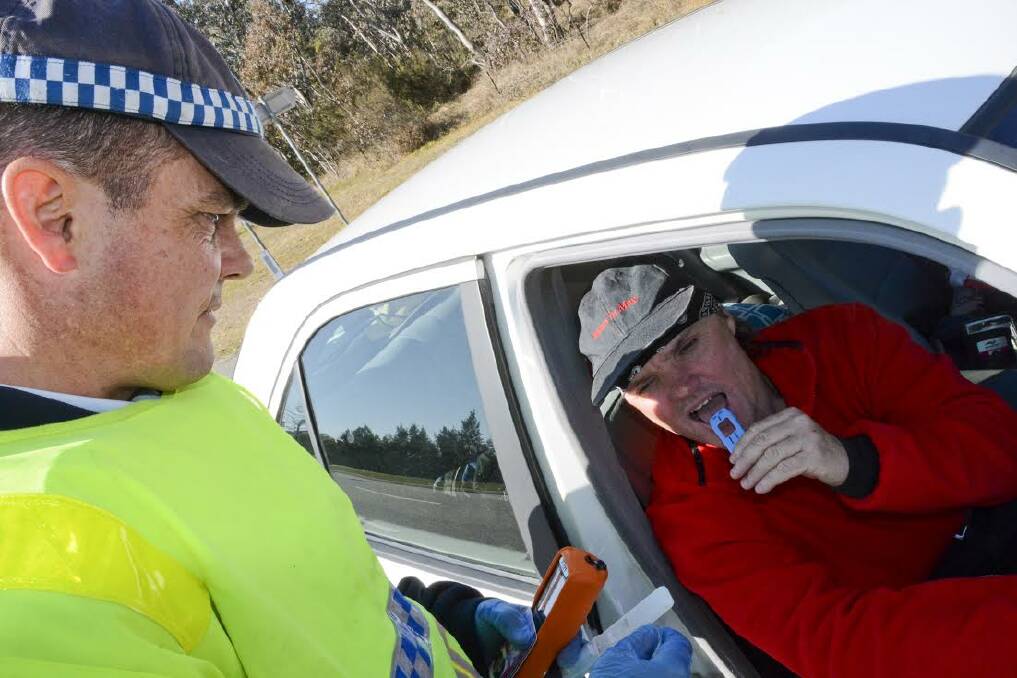 Queanbeyan horse whisperer Ged Davies is happy to be one that got away after a random roadside drug test by Monaro senior constable Geoff McKenzie. Photo: Ron Aggs.